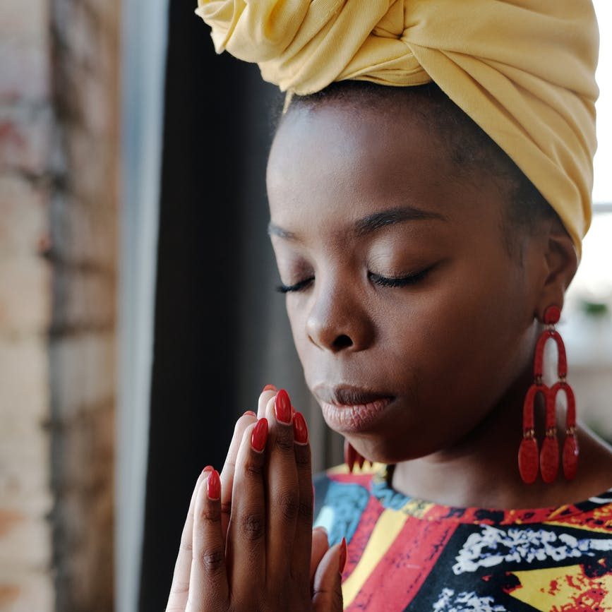 close up photo of woman praying